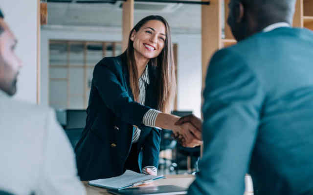 employer shaking hands with new employee